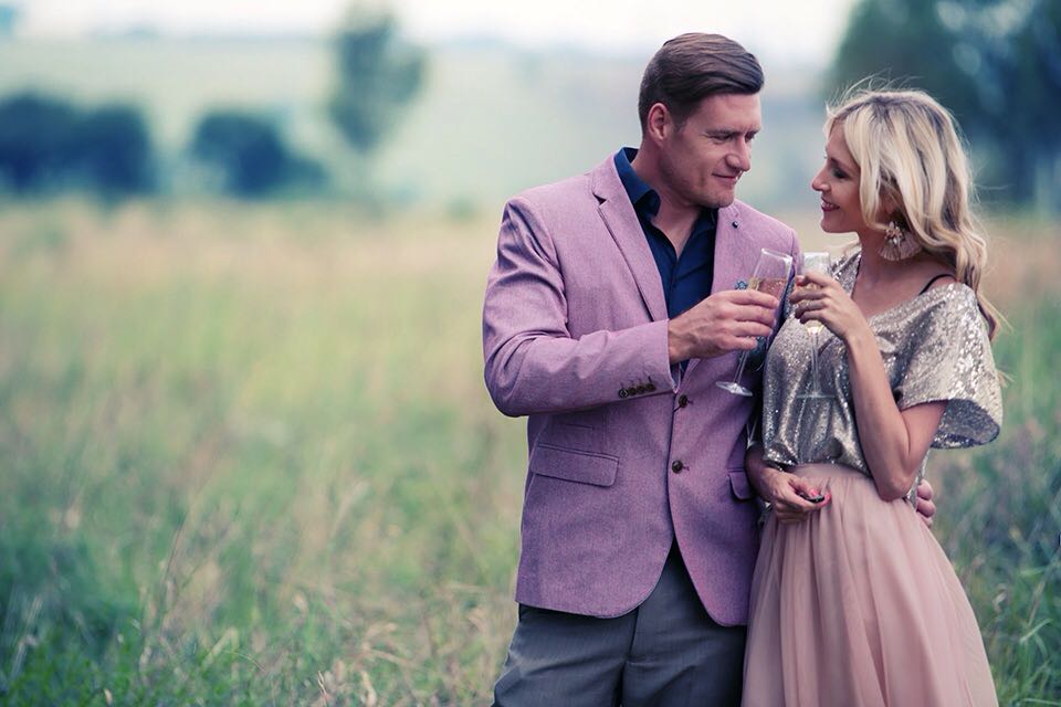 Couple formally dressed in a field